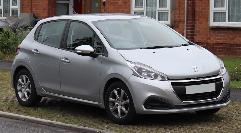 A Peugeot 208 car parked on the street with an engine oil pressure fault.