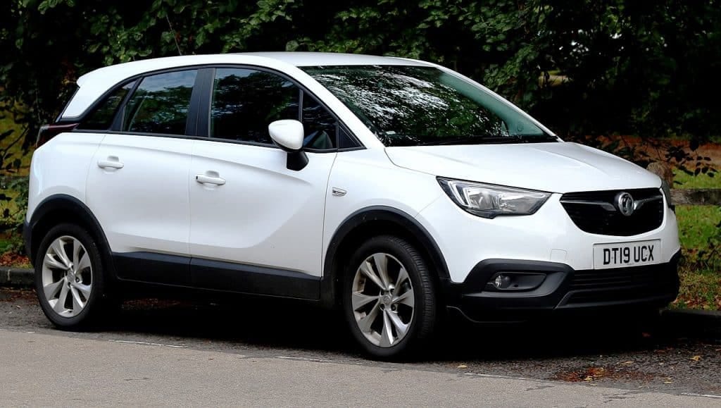 A white suv parked on the side of the road.