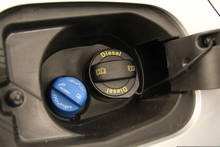 A close up of a fuel pump with a blue button.