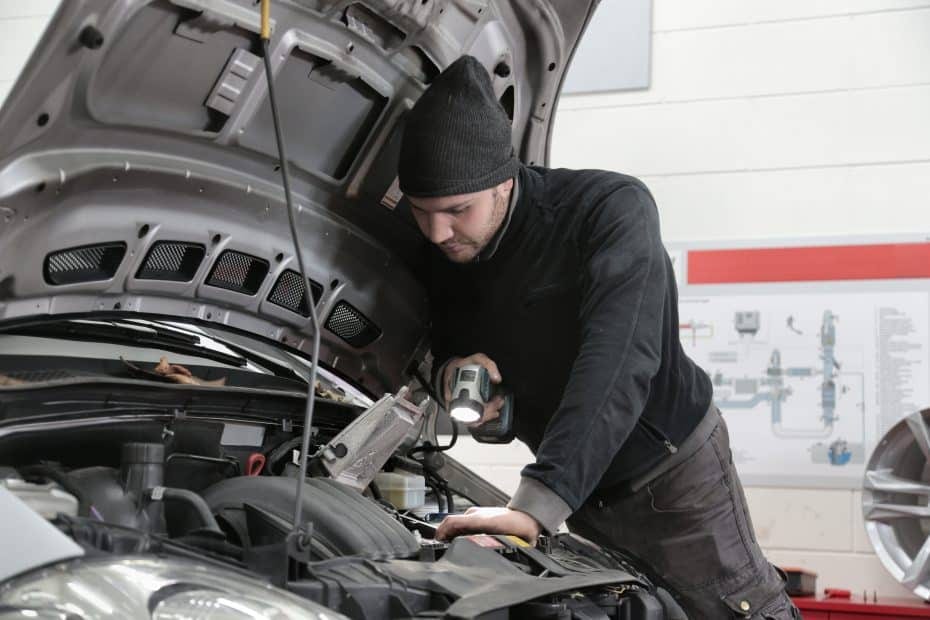 A man working on the engine of a car.