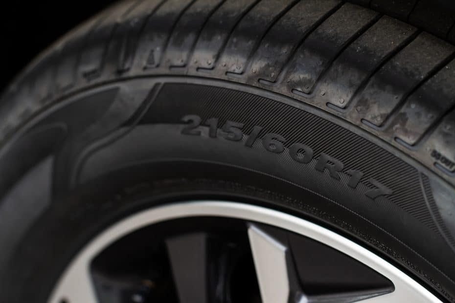 A close up of a tire on a black background.