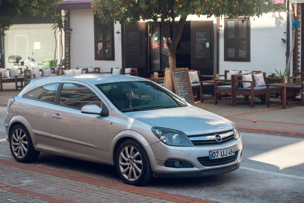 A silver car parked on a street.